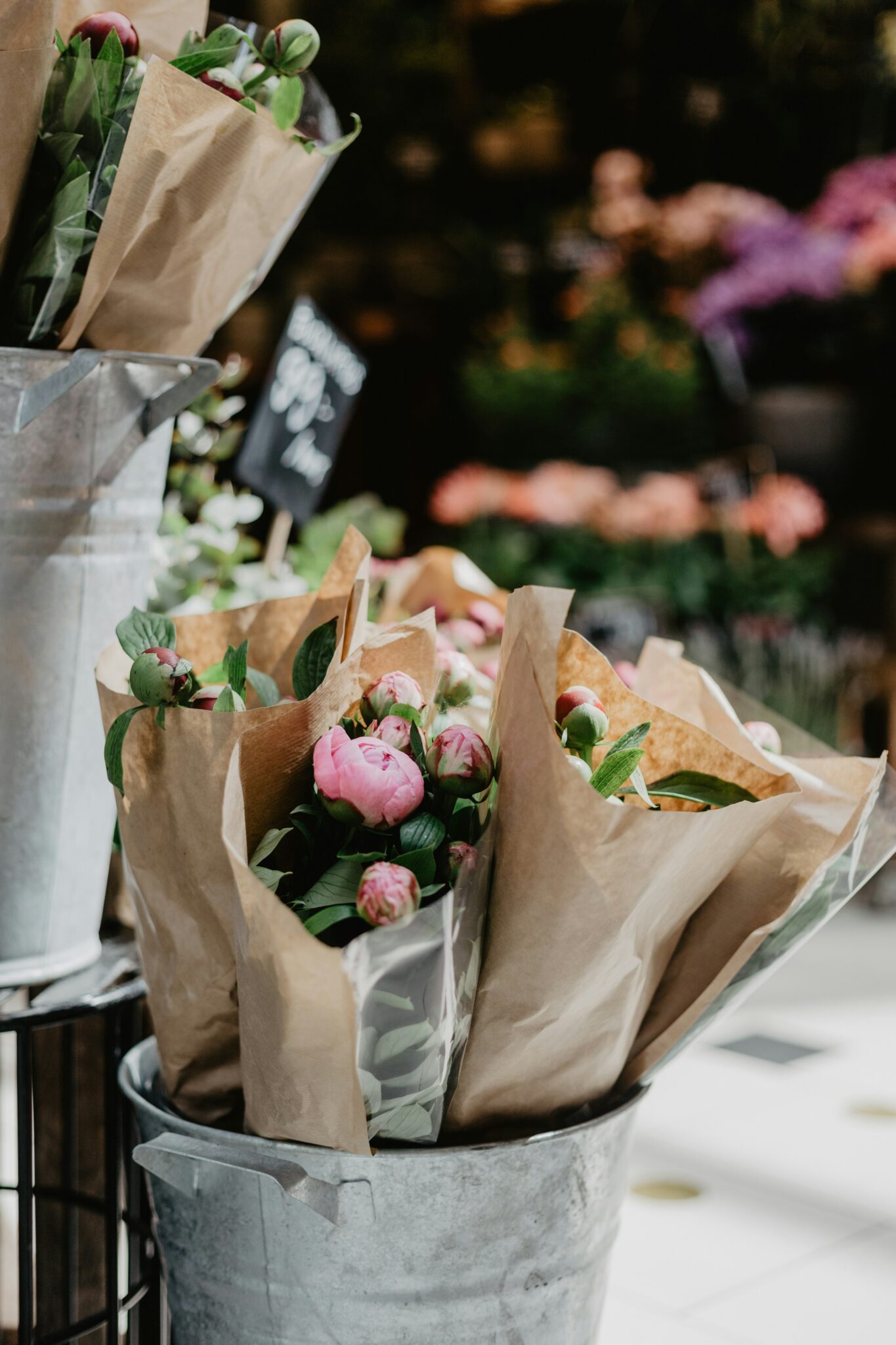 Fresh peony bunches in galvanised florist buckets